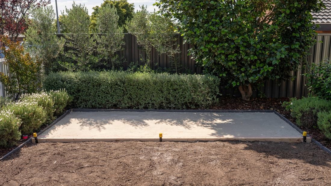 A prepared outdoor area features a leveled and compacted paver sand base 