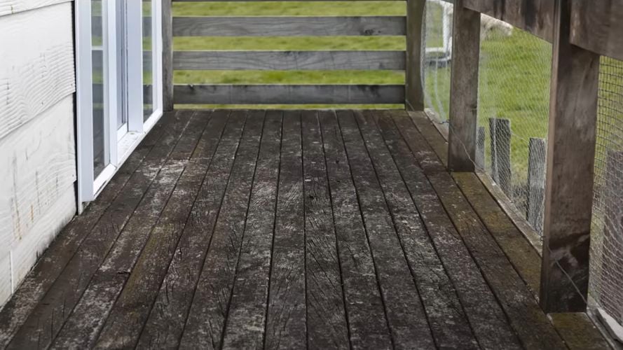 View of deck and fencing covered in dirt and grime.