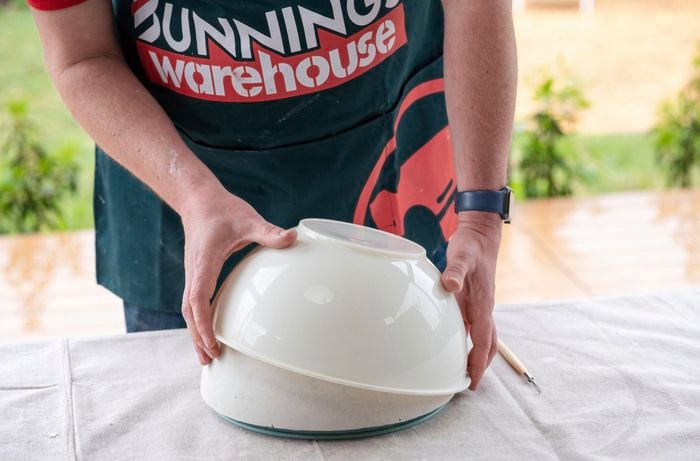 bunnings team member removing  plaster of paris out of the mould