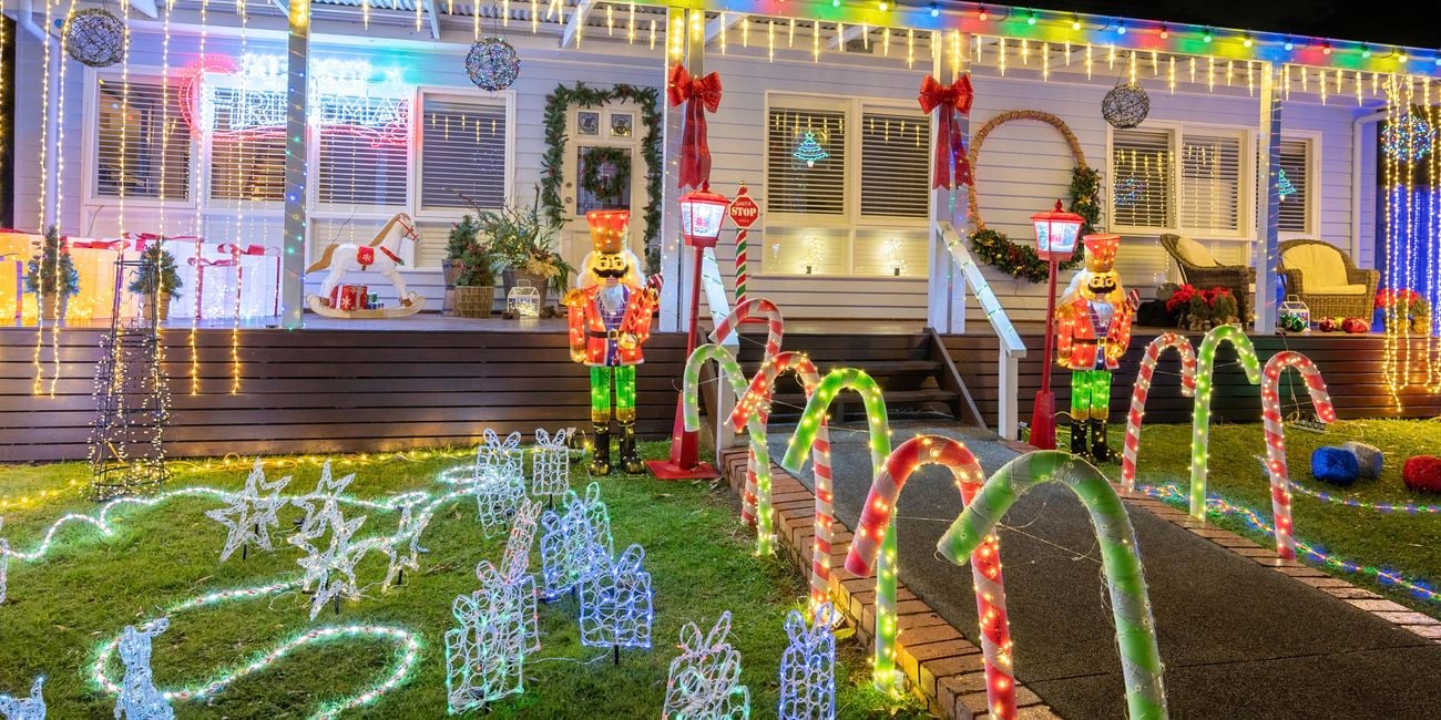 Front of house decorated with Christmas lights and decorations.