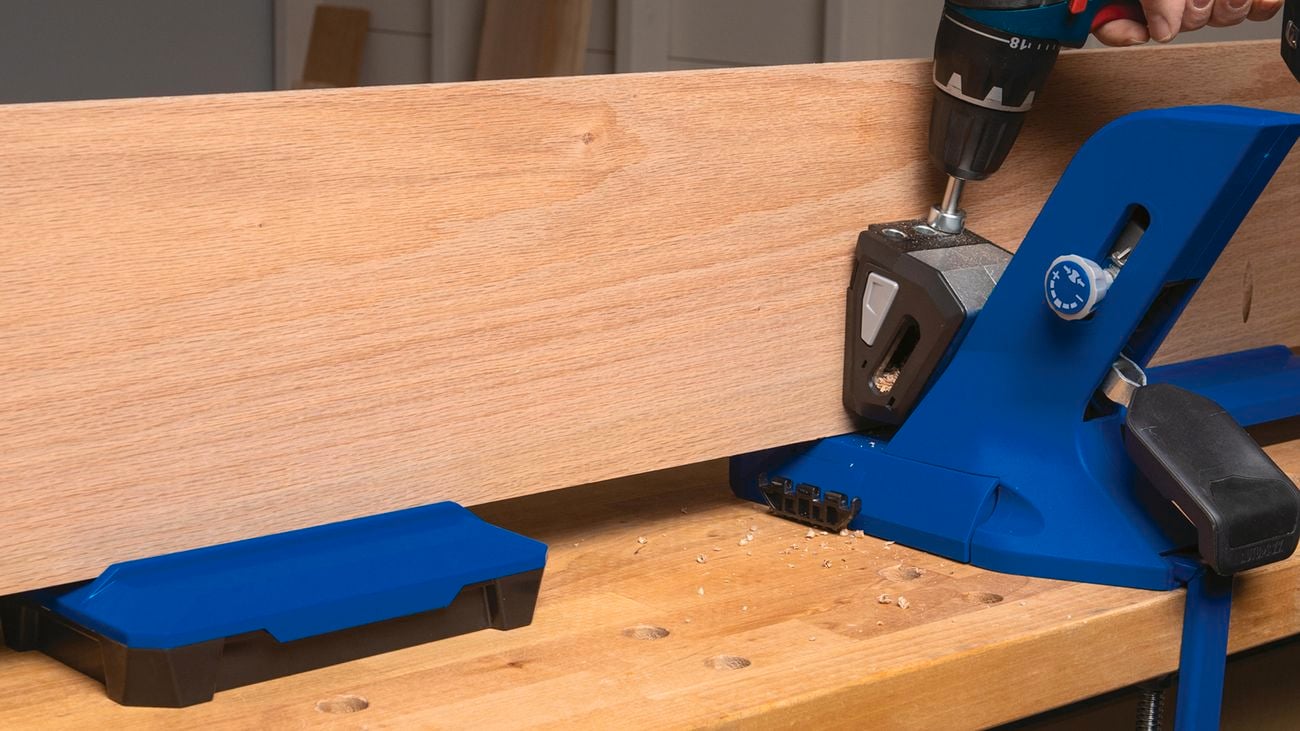 Timber being held together by a clamp.