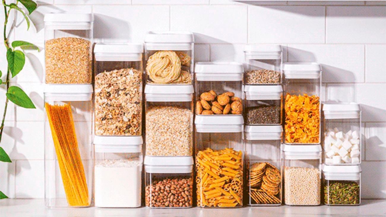 Storage cube canisters on kitchen bench with pasta, grains, muesli etc