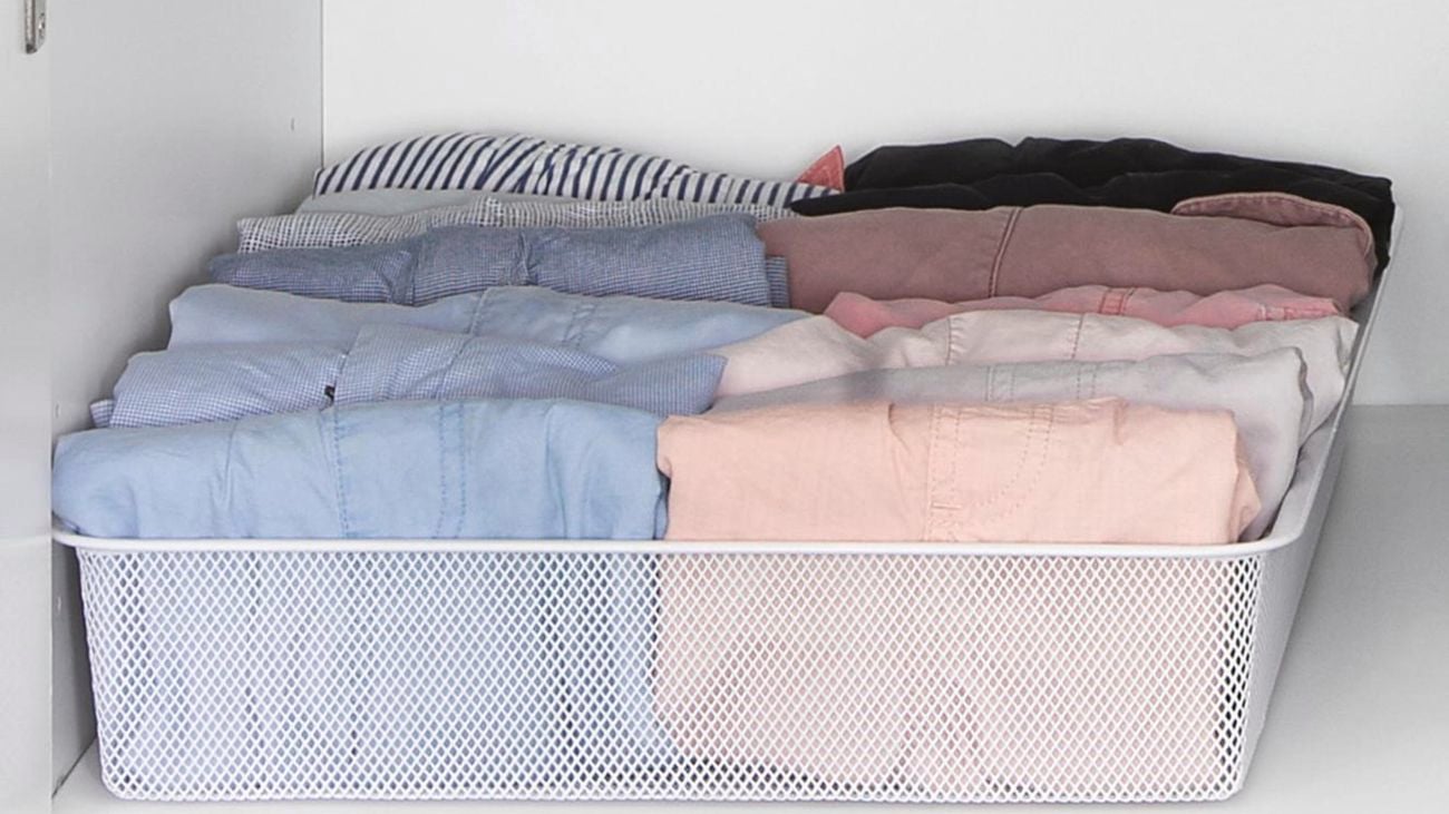 Clothes folded into a basket tray.