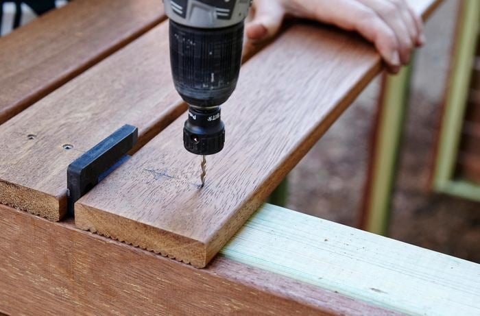 Person drilling timber together.