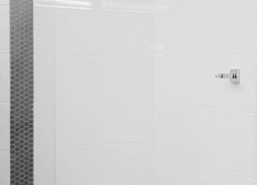 A chrome wall bracket is mounted on a white tiled wall 