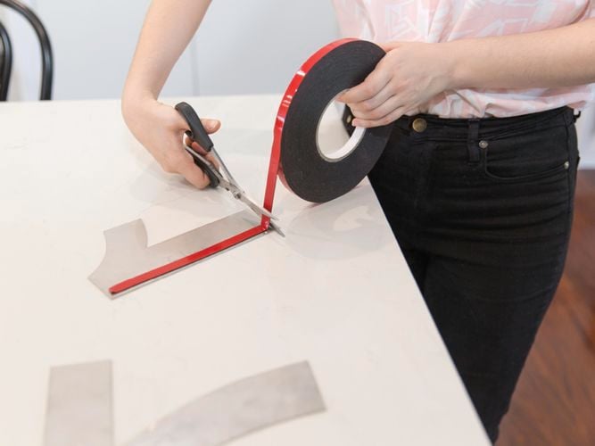 tape being  applied to a number plate
