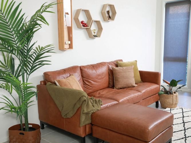 living room with floating shelves on wall