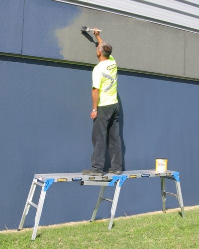 tradesperson working on a ladder