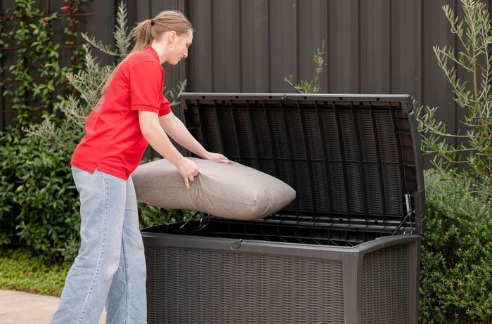 Placing a pillow in a weatherproof storage box