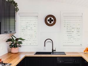 Tap in the kitchen with wooden deco on wall