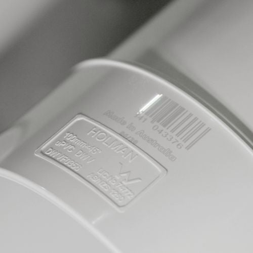 Close-up
  of a white Holman PVC DWV plumbing fitting