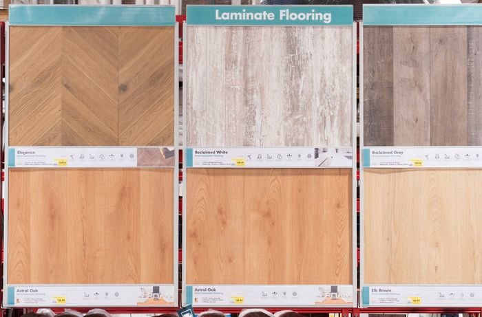 A small green label with Laminate flooring written on it, above samples of laminate flooring.