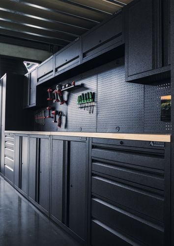 Ironheart Garage featuring the Pinnacle Pro Series Storage Stations and various pegboard hooks.