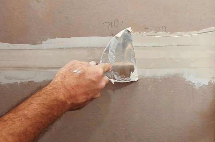 A spatula used to smooth plaster between two sheets of villaboard