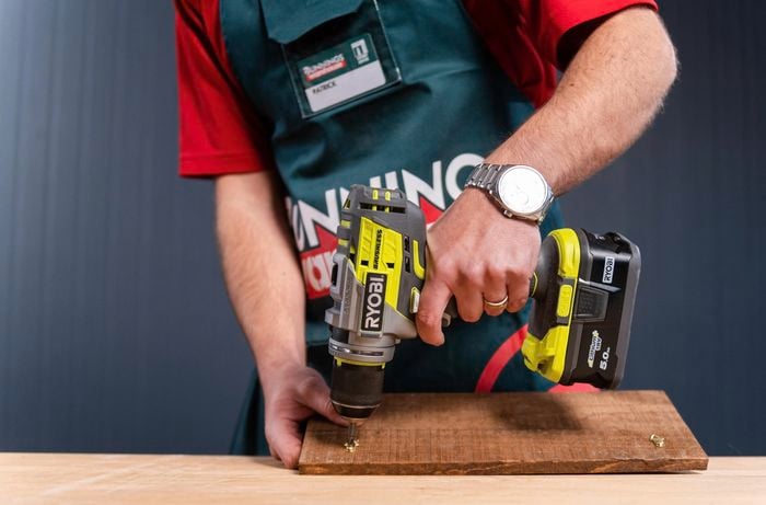 Using a power drill and drilling  into timber with screws