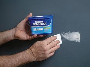 Hands opening Selleys Spakfilla in a blue container.