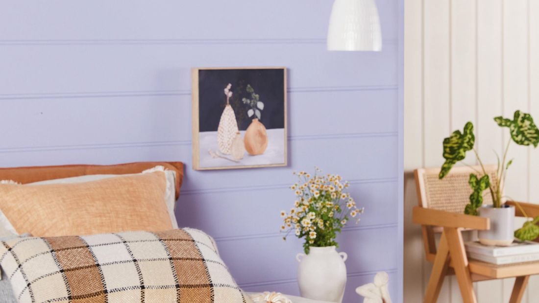 Nicely painted bedroom with purple walls.