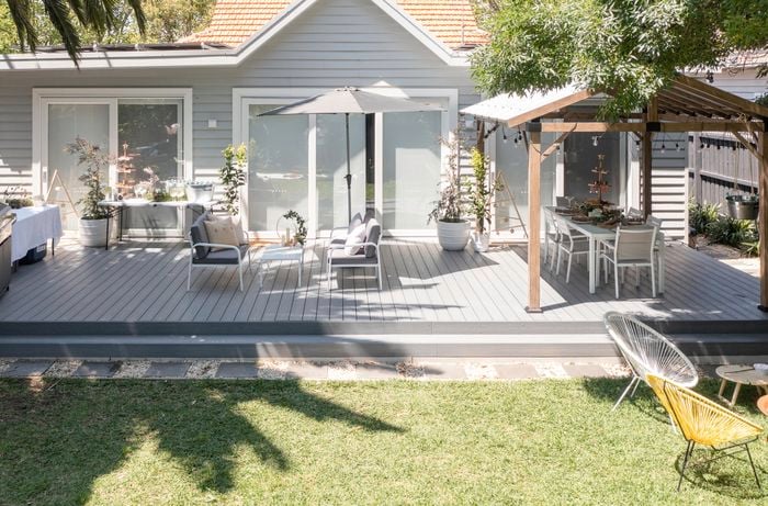Backyard with a decking, outdoor furniture and gazebo.