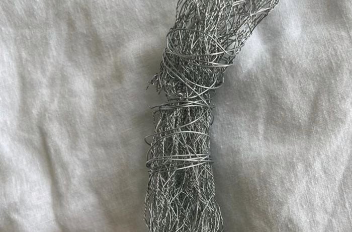 Using wire to join the ends of the bent chicken wire wreath together