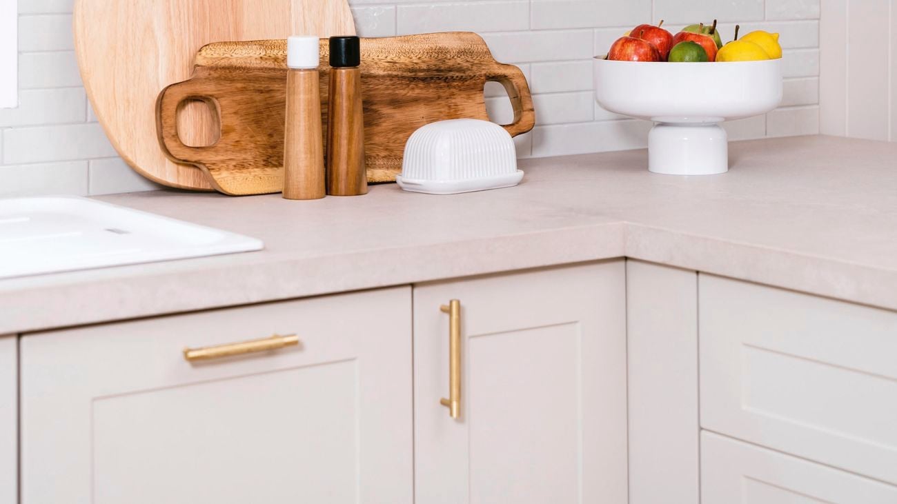 Floating timber shelves with gold brackets and kitchen benchtop