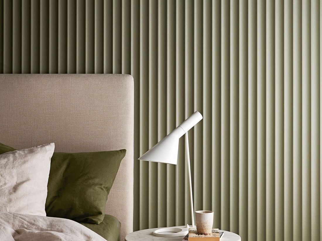 Bedroom area with a panelled wall in the background
