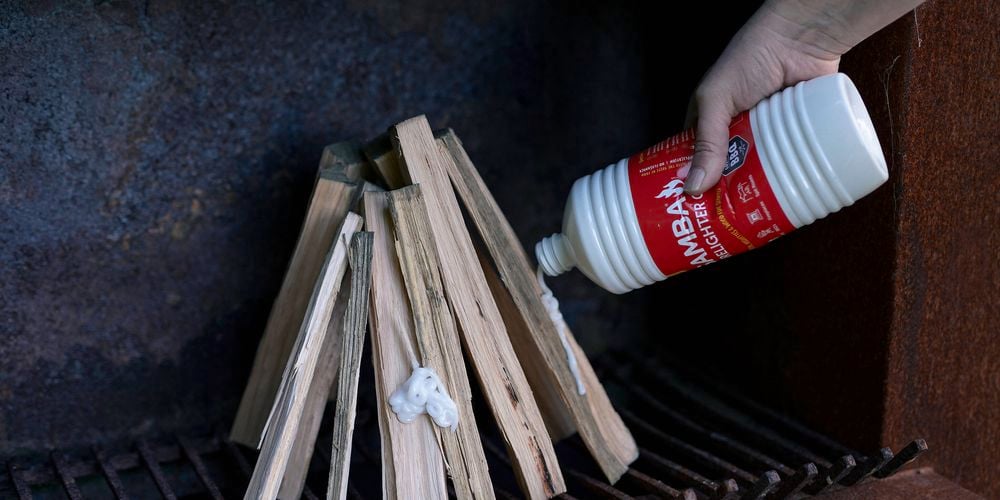 Samba
  1L Firelighter Gel (3180866) being squirted on a teepee stack of kindling in
  a fireplace