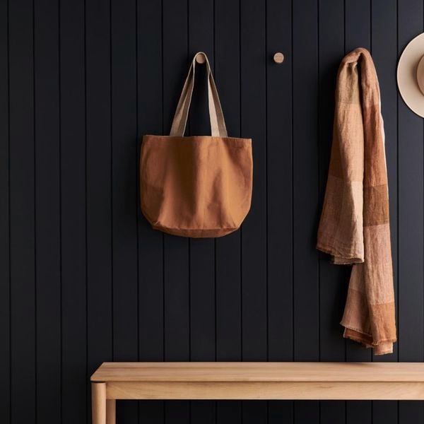 Neutral hanging bag, scarf and hat on hooks on the wall with a timber bench. Batten 100 design in Dulux Maximus.