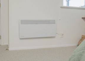 Heater installed on wall and plugged in ready to use
