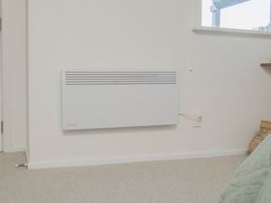 Heater installed on wall and plugged in ready to use