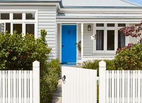 White house front with a blue door