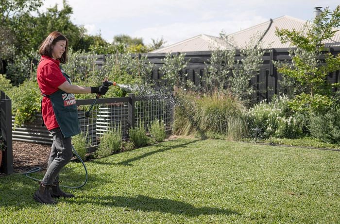A person watering the lawn.