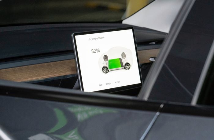 A Tesla's interior display shows charging has stopped at 82%, with no current power or energy flow.