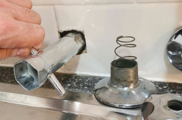 A tap being taken apart, now with the handles and parts removed.