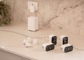Four security cameras on top of a countertop.