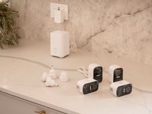 Four security cameras on top of a countertop.