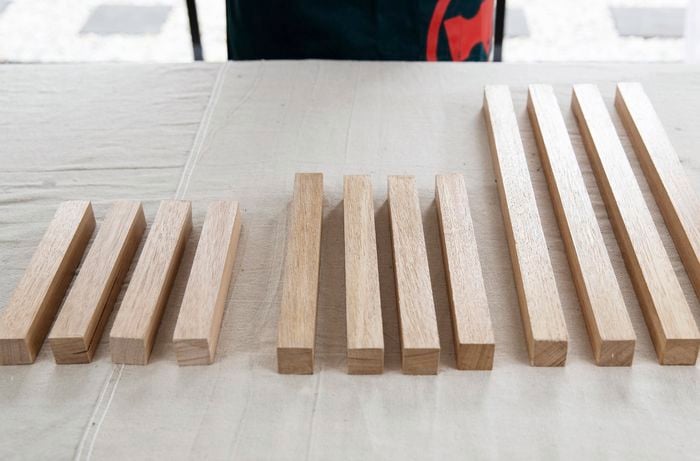 Twelve lengths of wood cut to size