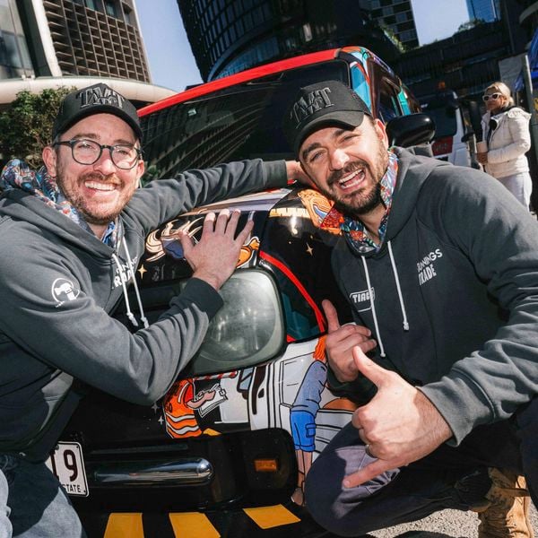 Two people from TIACS in Bunnings x TIACS hoodies