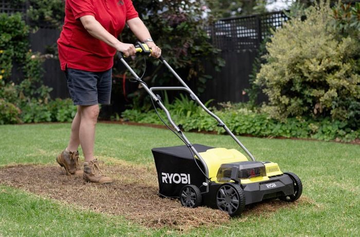 A Bunnings team member is using a brushless cordless scarifier.