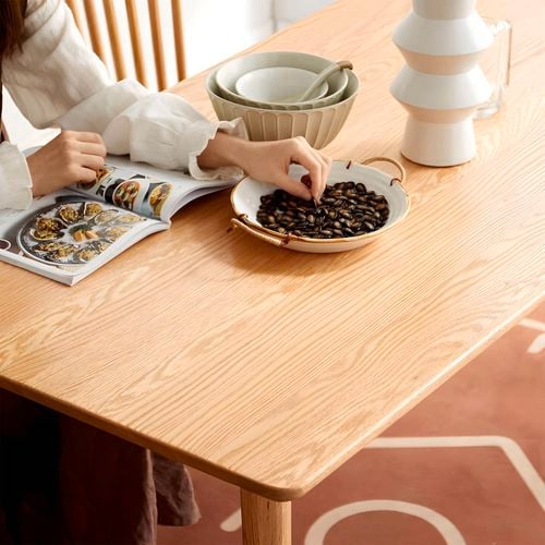 This minimalist dining table features a smooth natural wood finish and tapered legs for a clean, modern feel. I/N: 0651941