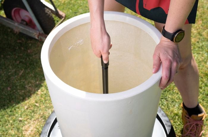 A Bunnings Team Member connecting extensions in a water feature