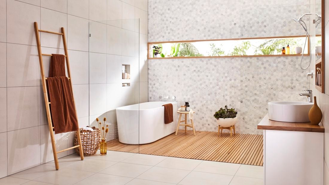 Organised bathroom featuring vanity unit, plant and ladder.