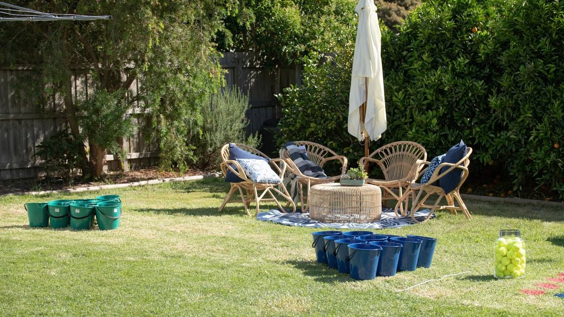Backyard with two sets of buckets lined up opposite each other.
