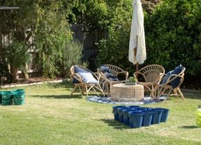 Backyard with two sets of buckets lined up opposite each other.