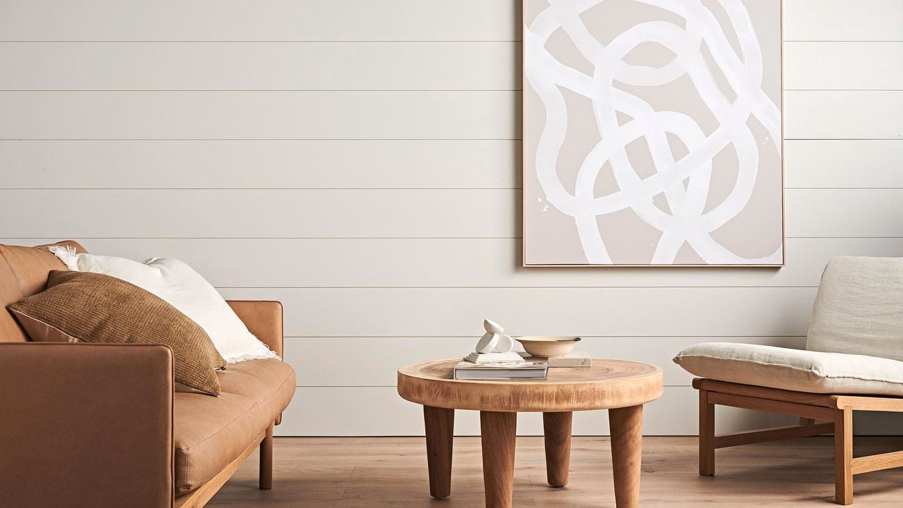Lounge seating area with a panelled wall in the background