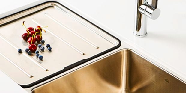 A kitchen sink with berries on it