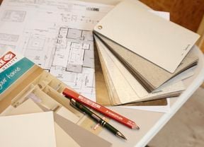 A house plan, colour swatch, pen and pencil on a desk