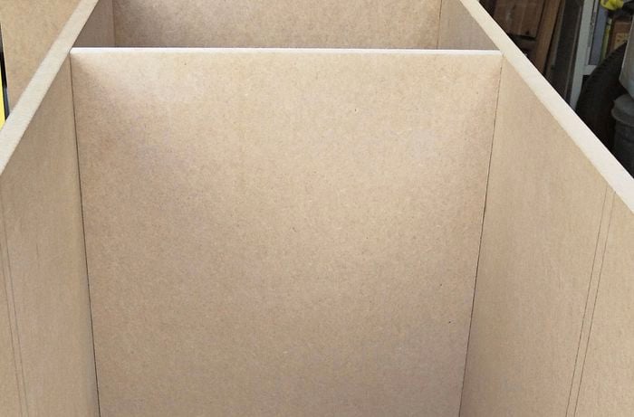 Divider positioned in between sides and base of cabinet.