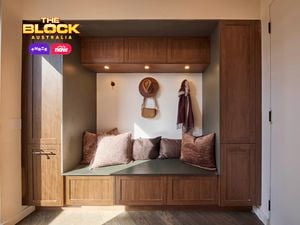 Mudroom nook from The Block with timber cabinetry, built-in bench, cushions, and wall hooks.