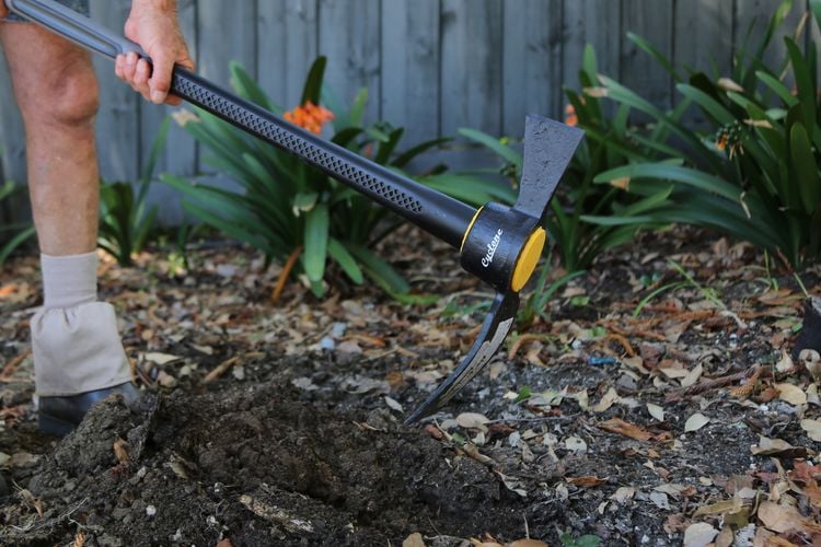 Soil being dug up with a mattock