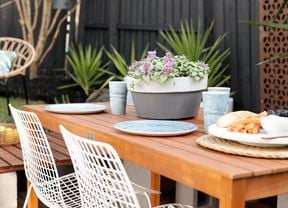 Painted terracotta pot on an outdoor dining table